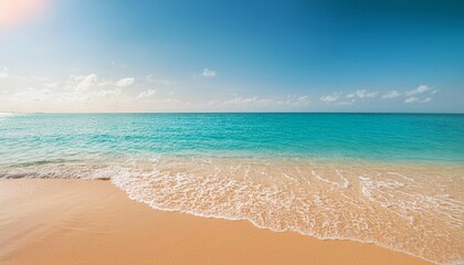 Fototapeta premium Sunny Beach With Golden Sand and Calm Waves Under Bright Blue Sky Midday
