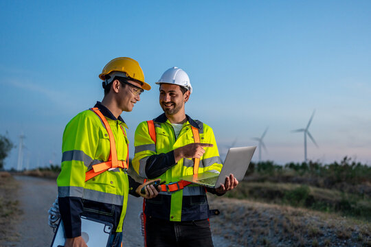 Diverse ethnicity male technicians working in the wind turbines field. 