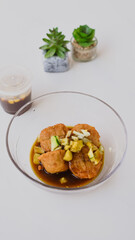 Pempek is the most authentic dish from Palembang, Indonesia. Served on a bowl with sweet spicy sour sauce and cucumber. Perfect for menu, catalogue, advertising or commercial use