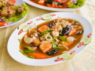 Close up Sapo Tofu. This dish consists of carrots, white cabbage, oyster mushrooms, shrimp, chicken. Served on a white plate. Perfect for menu, catalogue, advertising or commercial use