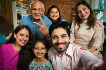Multigenerational Indian family of six enjoying a joyful moment as they take a happy selfie