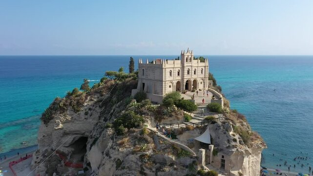 Aerial view of cliffs, historic tourist center of the city, monastery Santuario di Santa Maria dell'Isola di Tropea sunny summer day in Calabria region, Italy