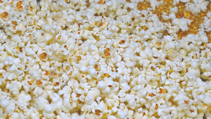 Full frame with popcorn, pile of sweet corn in the background