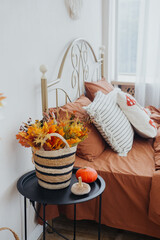 Cozy bedroom with autumn decor featuring warm colors and seasonal accents