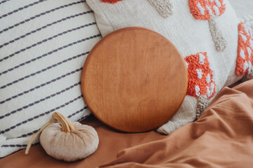 Cozy bedroom setting with a wooden round tray and decorative pillows on a bed