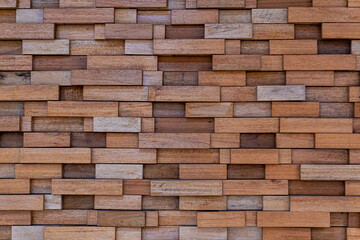 image of a wall covered in wood tiles of various sizes. wooden background texture concept.