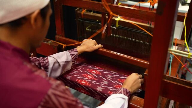 Traditional Indonesian hand weaving process using traditional tool