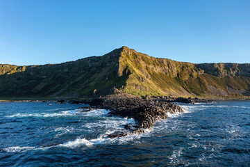 Giant's Causeway largest formation capturing basalt stones and tourists at sunset