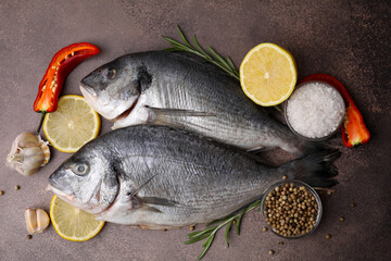 Sea food. Fresh raw fish and products on brown table, flat lay