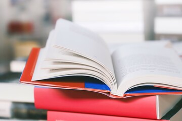 stack of books on the table. open book