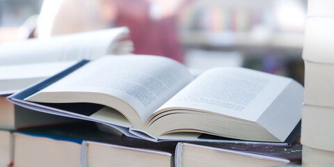 stack of books on the table. open book