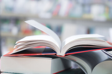 stack of books on the table. open book