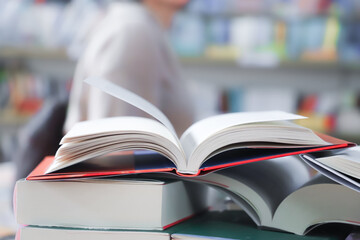 stack of books on the table. open book