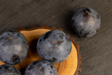 ripe purple plum on the table