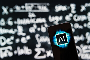 AI in school and math education. Science and mathematics with artificial intelligence app in phone. Equation, formula and function on chalkboard in classroom in college. Tool for teacher or student.
