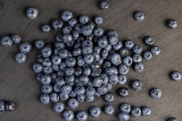 a pile of blueberries scattered on the board