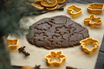 Rolled dough and cookie cutters for Christmas homemade gingerbreads.