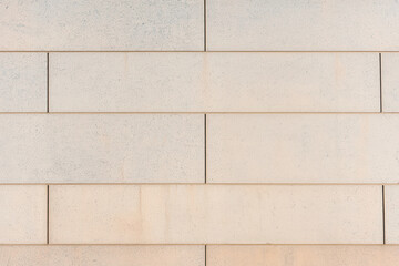 Textured stone wall with uniform rectangular blocks, white isolate background.