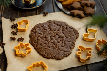 Rolled ginger dough and biscuit cutters for Christmas homemade cookies. 
