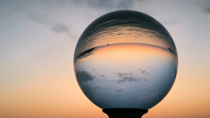 sunset by the Adriatic sea in Porec, seen through the glass lensball