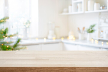 Empty wooden table ready for product montage on background of decorated Christmas kitchen background