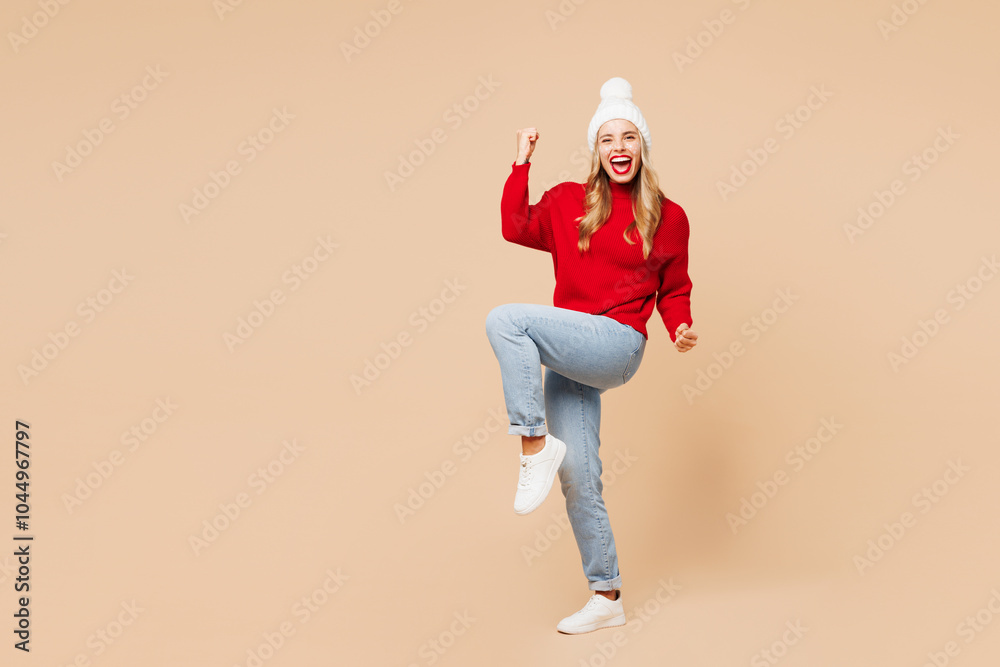 Wall mural full body merry young woman wear red warm christmas sweater hat posing do winner gesture celebrate c