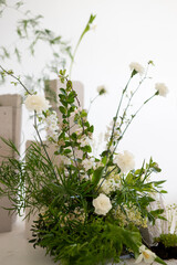 Elegant arrangement of fresh white flowers in a minimalistic setting with natural light illuminating the delicate petals
