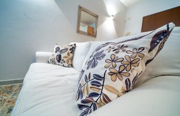 One-room bed and breakfast apartment, white interior design, open space: kitchen with dining table, living room with sofa