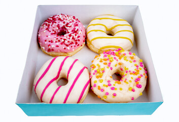 Image of four donuts in a box, ready to take to the office meeting or breakfast with the family.