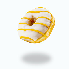 Flying donut made of white chocolate and yellow stripes with isolated on white background