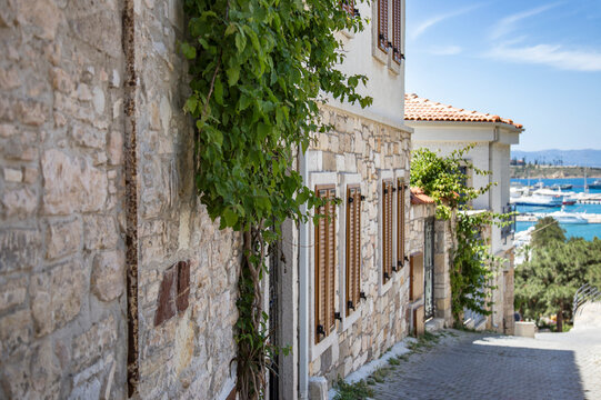 Stone street with İvy-covered house and sea view in Aegean Turkey, Cesme