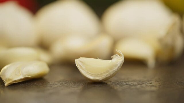 A close-up of a clove of garlic spinning on the table. Slow motion background video of vegetables. High quality FullHD footage