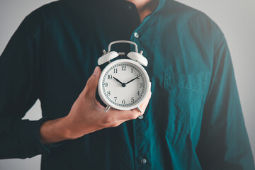 Time managment concept. Business man hold the clock . Work management concept.