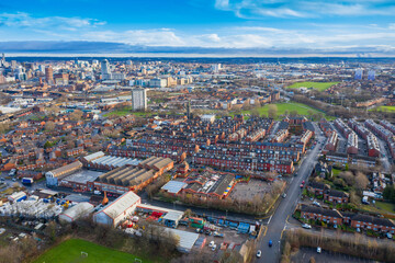 Obraz premium Aerial photo of the town of Hunslet in Leeds West Yorkshire in the UK, showing roads and rows of residential houses taken in the winter time with the Leeds city centre in the background