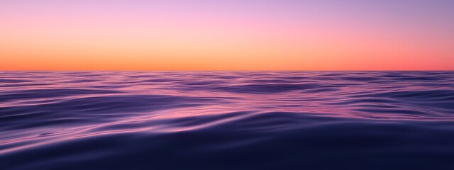 A calm sea at sunset, with the horizon blending into a gradient of purples and oranges, creates an atmosphere that feels serene and peaceful.