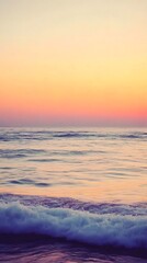 Fototapeta premium A calm sea at sunset, with the horizon blending into a gradient of purples and oranges, creates an atmosphere that feels serene and peaceful.