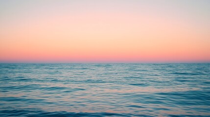 Obraz premium A calm sea at sunset, with the horizon blending into a gradient of purples and oranges, creates an atmosphere that feels serene and peaceful.