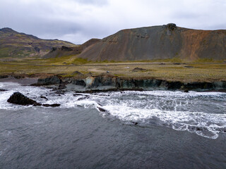 Panorama of Laekjavik beach rock formation sea stack black sand atlantic ocean coast tower east fjords Iceland Europe