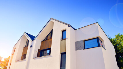 Residential homes with modern facade.Terraced family homes in newly developed housing estate. The real estate market in the suburbs. New single family houses in a new development area. 