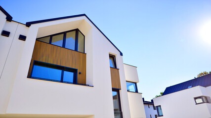 Residential homes with modern facade.Terraced family homes in newly developed housing estate. The real estate market in the suburbs. New single family houses in a new development area. 