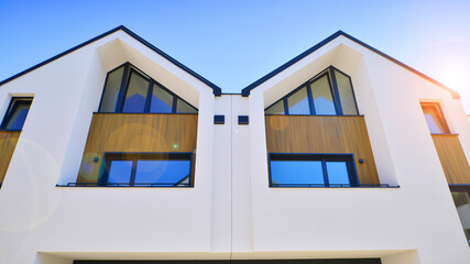 Residential homes with modern facade.Terraced family homes in newly developed housing estate. The real estate market in the suburbs. New single family houses in a new development area. 