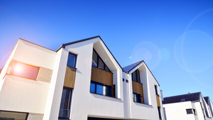 Residential homes with modern facade.Terraced family homes in newly developed housing estate. The real estate market in the suburbs. New single family houses in a new development area. 
