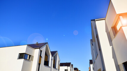 Residential homes with modern facade.Terraced family homes in newly developed housing estate. The real estate market in the suburbs. New single family houses in a new development area. 