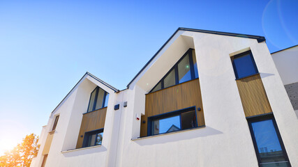Residential homes with modern facade.Terraced family homes in newly developed housing estate. The real estate market in the suburbs. New single family houses in a new development area. 