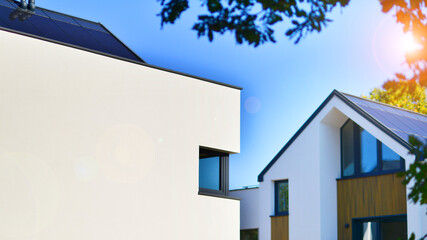 Residential homes with modern facade.Terraced family homes in newly developed housing estate. The real estate market in the suburbs. New single family houses in a new development area. 