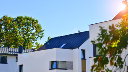 Harmony with nature, eco architecture. Terraced single family homes in newly developed housing estate. The real estate market in the suburbs with lush greenery surrounding. 