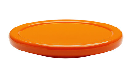 Bright orange disc resting on a plain surface evokes playful outdoor activities on a sunny day