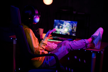 Full length photo of gamer lovely young lady watch stream eat pop corn drink tea play strategy game gamer laptop late night room indoors