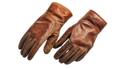 Classic worn leather gloves resting on a rustic wooden table in soft natural light