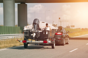 Car towing boat on the open road